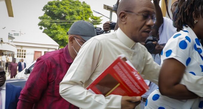 Emefiele Arrives Court Clutching Bible for Firearms Allegations Hearing.